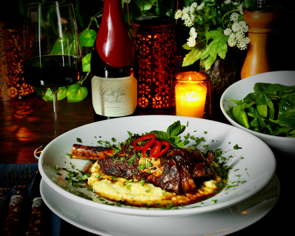 Slow-Braised Lamb Shanks, Pomegranate and Fig Sauce, Over Boursin Cheese Polenta